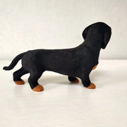 Black dachshund plush toy on a white background