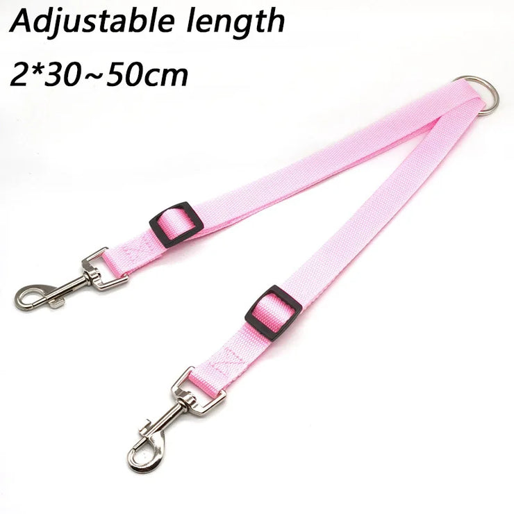 Pink dog leash with metal clips on a white background